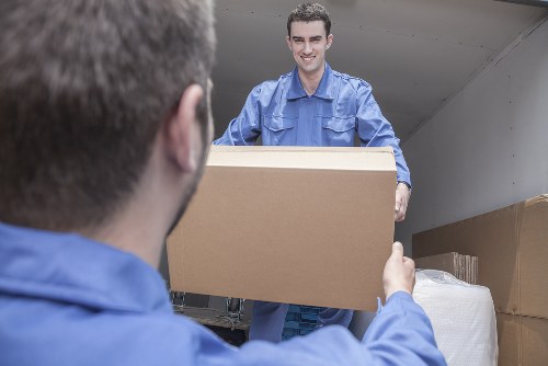 Moving team handling boxes safely during a removals job