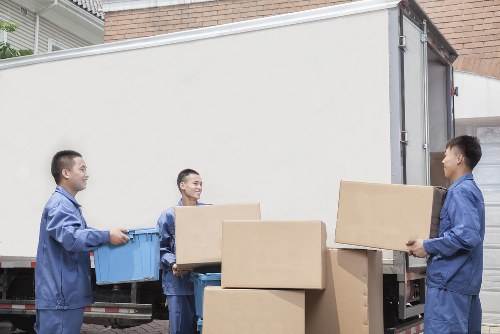 Driver securing items inside a removal van for safe transport