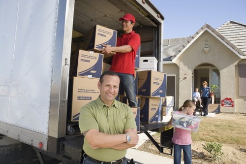 Movers carrying furniture through a Cotland home