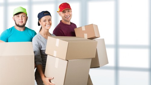 Removal team loading household items into a vehicle