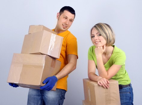 Professional movers preparing items for transport before a relocation