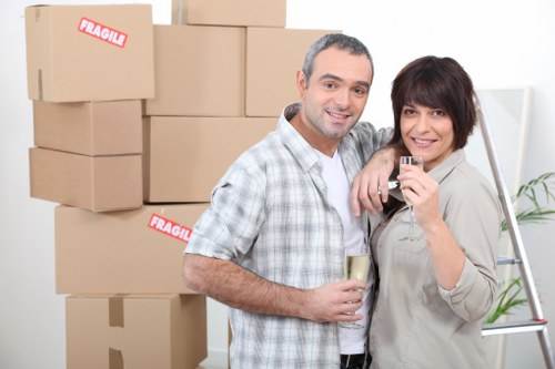 Staff member wearing PPE while handling boxes during removals work